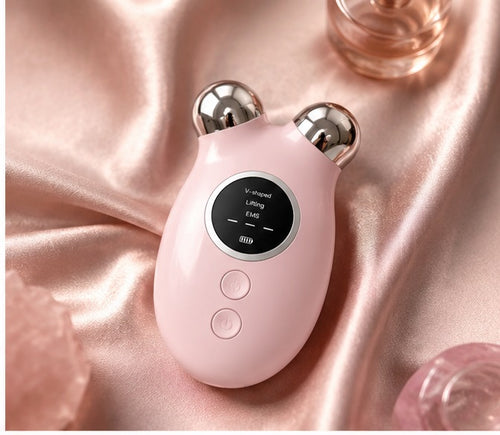 EMS Microcurrent Facial Lifting Device on satin fabric — luxury product shot