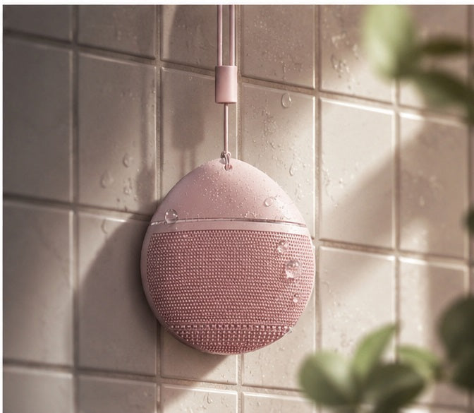 Sonic Silicone Facial Cleansing Brush hanging on tile wall — bathroom use